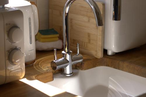 a kitchen sink with a faucet on a counter at The Beeches in Scarisbrick