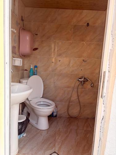 a bathroom with a toilet and a sink at Light in August in Kobuleti