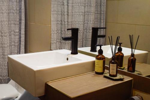 a bathroom with a sink and two bottles on a counter at Casa Nilhue Camino a Farellones in Lo Barnechea