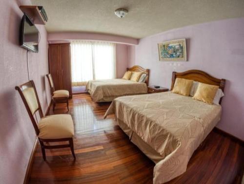 Tempat tidur dalam kamar di Hotel Rocío