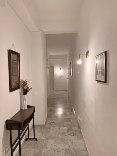 a hallway with white walls and a wooden table at La casa di Michelle in Foggia