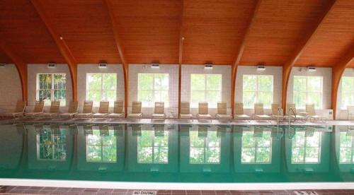 a large swimming pool with chairs in a building at Tanglwood Resort in Hawley