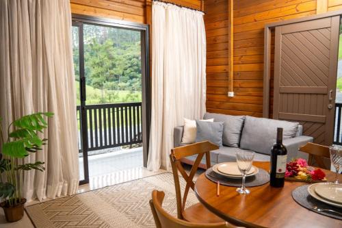 a living room with a table and a couch at Sítio Monte Frederico in Nova Trento
