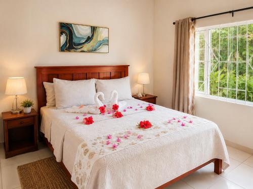 a bedroom with a bed with flowers on it at AG3K Oasis in Buccoo
