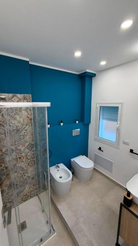 a bathroom with a shower and a toilet and a sink at San Lorenzo Palace in Reitani