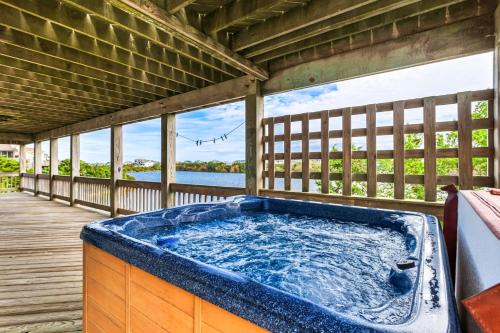 a hot tub on the deck of a house at 8198 - Still Waters in Waves