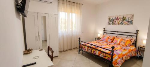 a bedroom with a bed and a table and a window at La Fattoria dei Desideri in Ripa Teatina