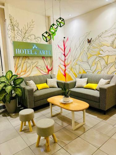 a lobby with couches and a coffee table and a sign at Hotel y Arte Antigua by Amazing Guatemala Travel in Antigua Guatemala