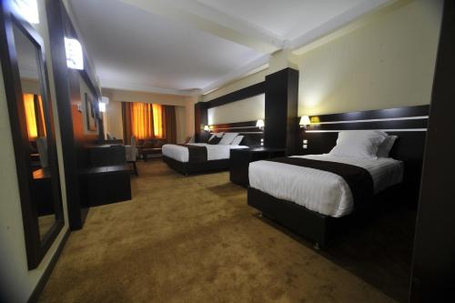 Postel nebo postele na pokoji v ubytování Numidien Hotel