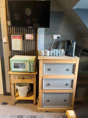 a toy kitchen with a microwave on a dresser at BELLFIELD HOUSE in Broadford