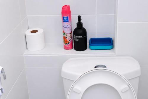 a shelf above a toilet in a bathroom at Soft stay homes in Mombasa