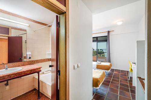 a bathroom with a sink and a mirror at HI Almada - Pousada de Juventude in Almada
