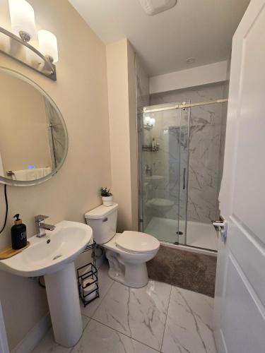 a bathroom with a toilet and a sink and a shower at 1 bedroom apartment in Halifax