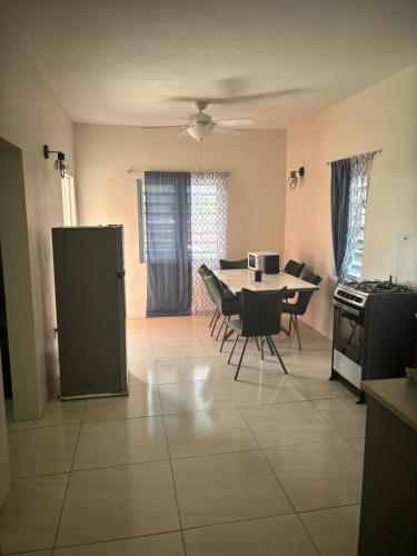a kitchen and dining room with a table and chairs at Caroline suite in Cliftons