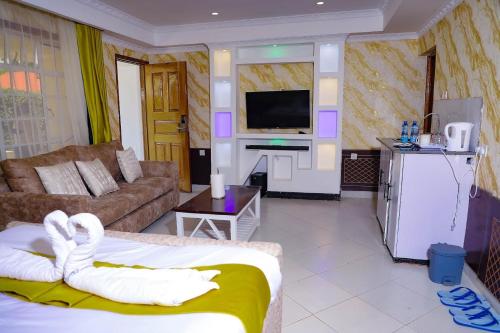 a living room with a couch and a tv at Lee Njiru Resort in Nakuru
