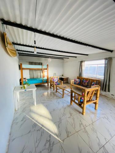 a living room with two chairs and a couch at Holgger House in Talara
