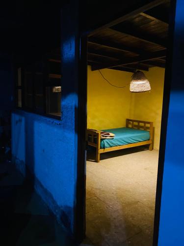 a bedroom with a bed in a yellow room at Holgger House in Talara