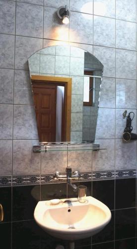 a bathroom with a sink and a mirror at Casa Mare & Monti in Budva