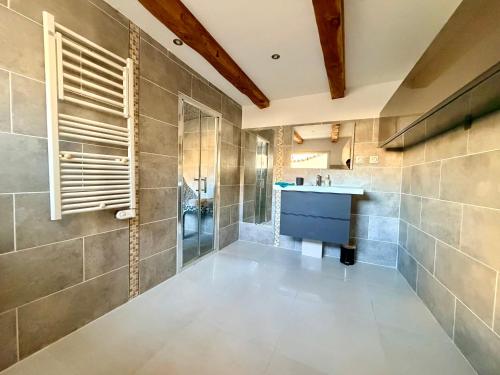 a bathroom with a sink and a shower at L'Écrin de Valensole, Charme & terrasse in Valensole