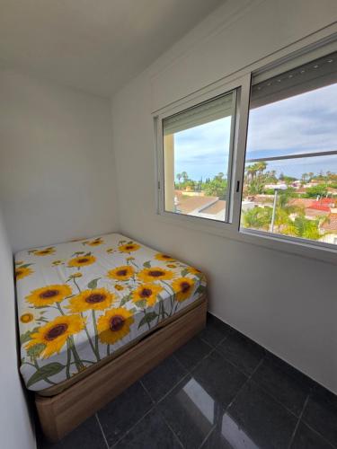 a bedroom with a bed and two windows at Entre Aguas in L'Eucaliptus
