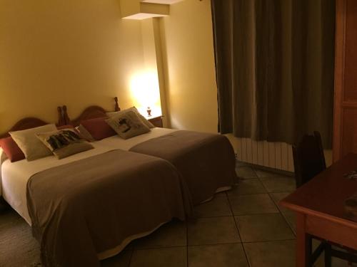 a bedroom with a large bed in a room at La Fusteria del Casat in Sarroca de Bellera