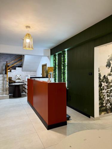 a kitchen with green walls and a red counter at Boutique Hotel Pui de Urs Fundata in Ciocanu