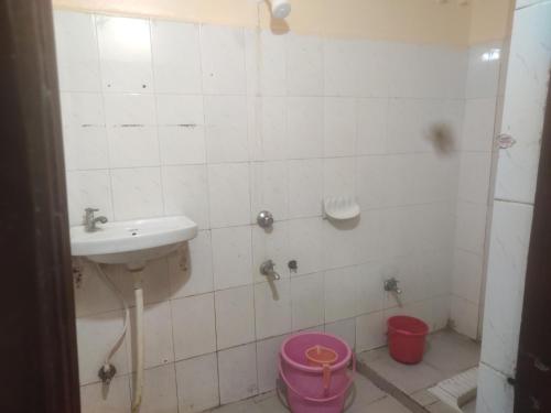 a bathroom with a sink and a toilet at HoTEL LAALASA in Vijayawāda