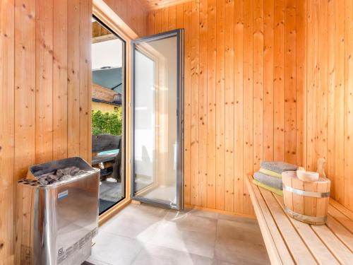 a room with wooden walls and a sliding glass door at Chalet Alpenzauber mit beheiztem Pool, Inzell in Inzell