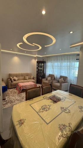 a living room with a table and couches and a circular ceiling at Rèsidance Mimosa in Bejaïa