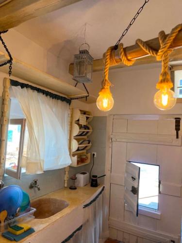 a kitchen with two lights and a sink at Palirroia (High Tide) in Empourios