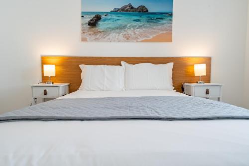 a bedroom with a bed and two nightstands at Casa Turalves - By WeHostMadeira in Porto Santo