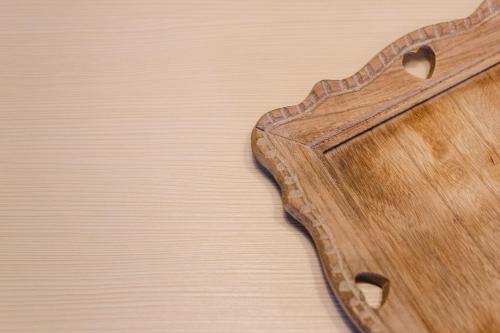 a wooden guitar laying on a wooden table at Luxury Chalet Mallnitz in Mallnitz
