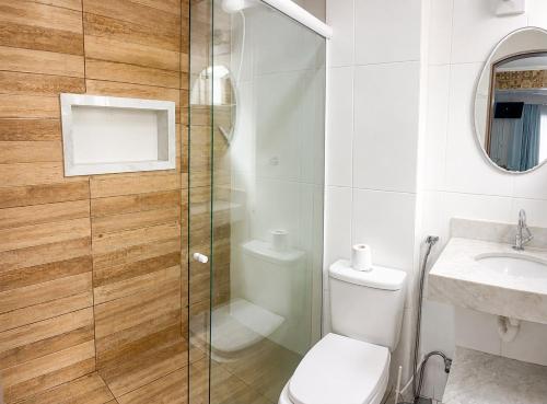 a bathroom with a shower and a toilet and a sink at G2 Hospedagem Suites & Studio Praia Dos Anjos in Arraial do Cabo