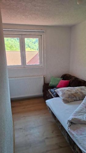 a room with a couch and a window at Nature House in Pljevlja