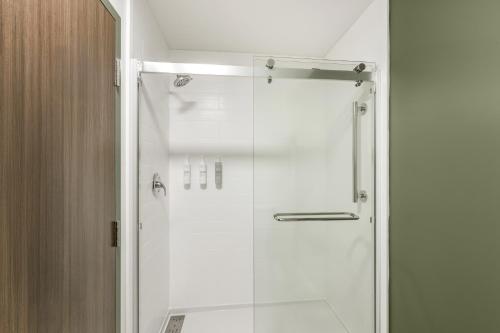 a shower with a glass door in a bathroom at Spark By Hilton Freeport in Freeport