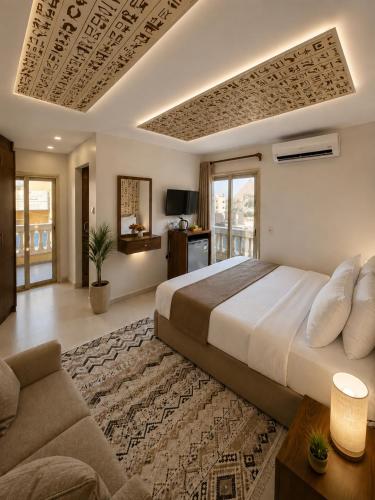 a bedroom with a large bed and a couch at Miami Pyramids View in Cairo