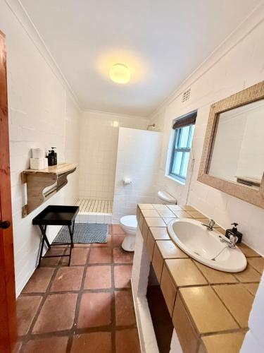 a bathroom with a sink and a toilet at Coast Cottages Langebaan in Langebaan