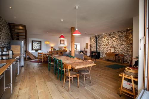a kitchen and dining room with a wooden table and chairs at Chalet l'Arva in Saint-Marcel