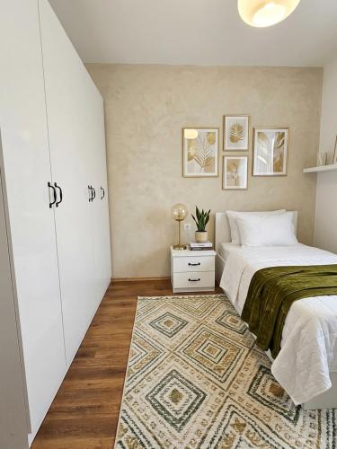 a bedroom with a bed and a rug at Spacious Central Apartment with Panoramic Views in Tirane