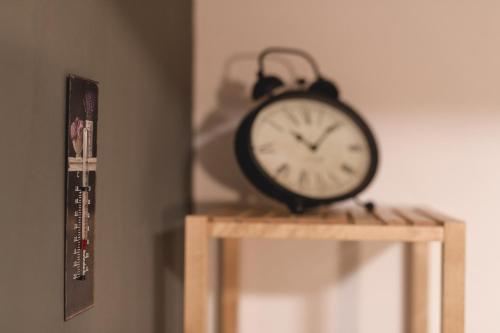 a clock sitting on top of a wooden table at Luxury Chalet Mallnitz in Mallnitz