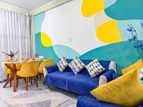 a living room with a blue couch and a table at Riti Wasi in Yungay