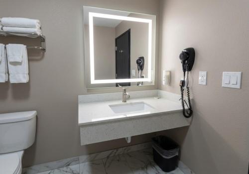 a bathroom with a sink and a phone at Quality Inn Texarkana Arkansas in Texarkana