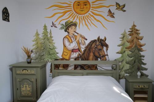 a bedroom with a mural of a boy riding a horse at Raiul Sânzienelor in Sărata-Monteoru