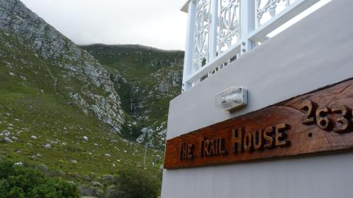 a sign on the side of a building with a mountain at The Trailhouse in Bettyʼs Bay