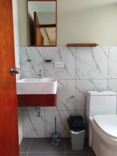 a bathroom with a sink and a toilet at Hotel Rodilla in Ayacucho