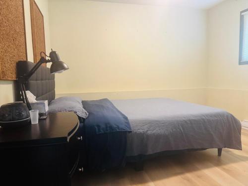 a bedroom with a bed and a desk with a lamp at Zoe house in Victoria