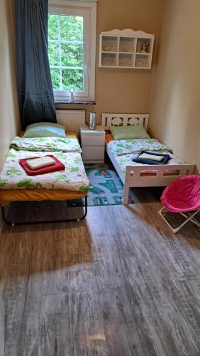 a bedroom with two beds and a window at Villa Tingsryd nära stranden in Tingsryd