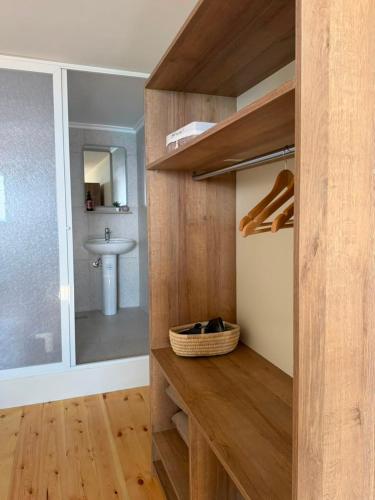 a bathroom with a sink and a counter with a sink at CBreeze Guesthouse in Batroûn