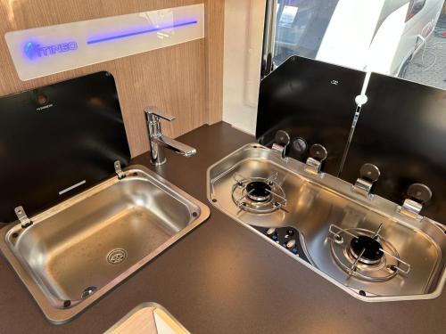 a kitchen with a stainless steel sink and a counter at Neptun Beach Caravans in Ulcinj