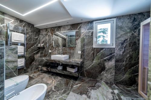 a bathroom with a sink and a mirror at Hotel Lago Bin in Rocchetta Nervina